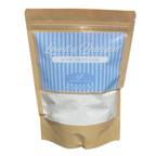 Laundry detergent package with blue label and brown packaging on a white background