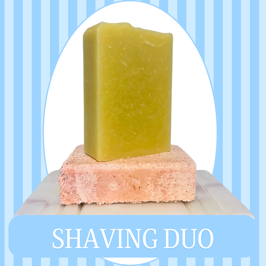 Blue Striped Background with White Oval Frame of a set of soaps sitting on a  soap dish. One is a pink Rose Quartz Salt Bar, the other is a White colored Shaving Bar. The text reads Shaving Duo.